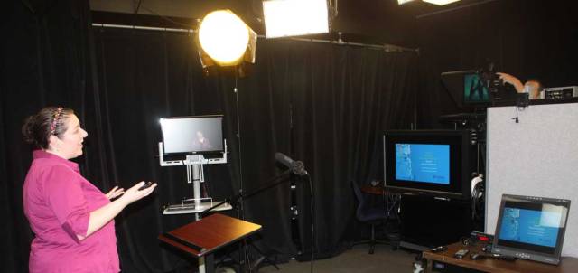 Jaclyn Rhoads setting up to record online teaching presentation.